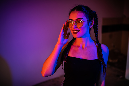 Fashion model Girl in Neon Lights. Beautiful studio photo in colorful bright light