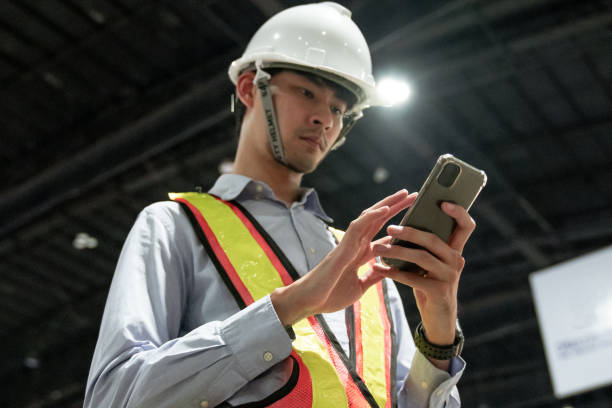 istock Engineer in the Hard Hat Walks Factory While Holding tablet 1257633160