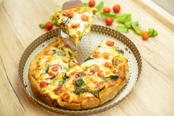 A delicious slice of pizza from which the cheese melts stock photo