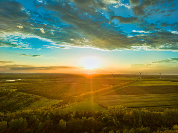 istock Landscape the wind wheels with a bright undergoing sun in the horizon, renewable energy production. 1257633468