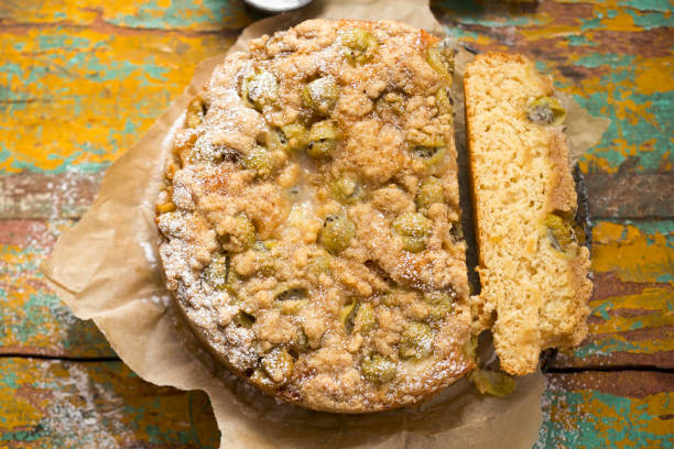 Yoghurt gooseberry cake with crumble and icing sugar
