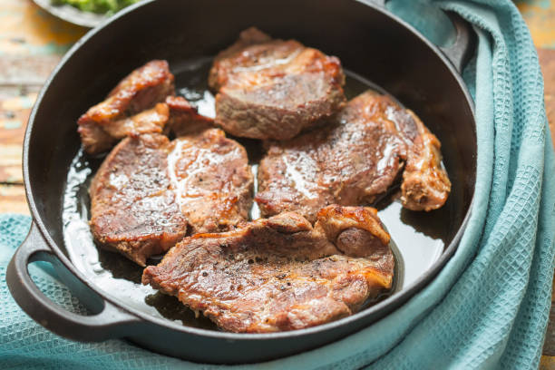 istock Pork shoulder in white wine with broad beans & herbs pesto 1257634593