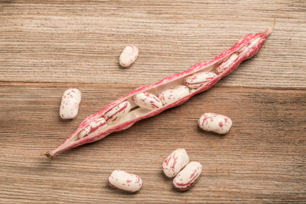 closeup raw kidney beans on a wooden table