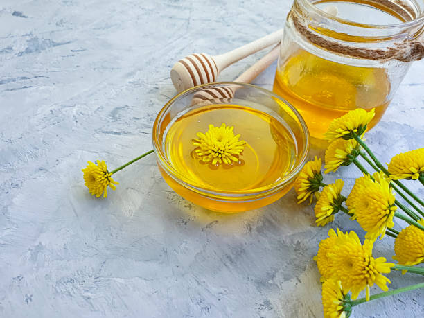 istock fresh honey yellow flowers on concrete background 1257645617