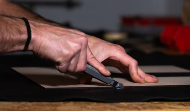 istock craftsman working with hands and cutter leather 1257646365