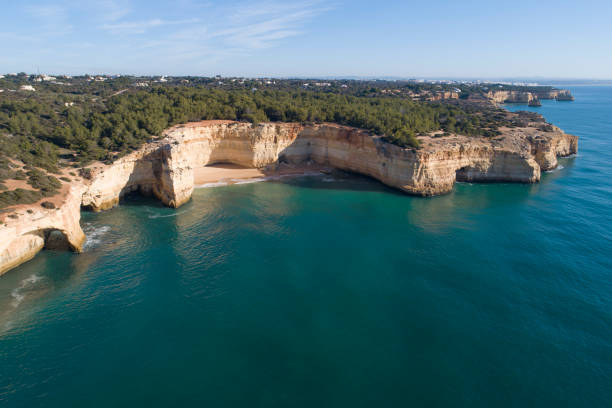 istock Benagil caves from aerial view and algarve cliffs 1257646426