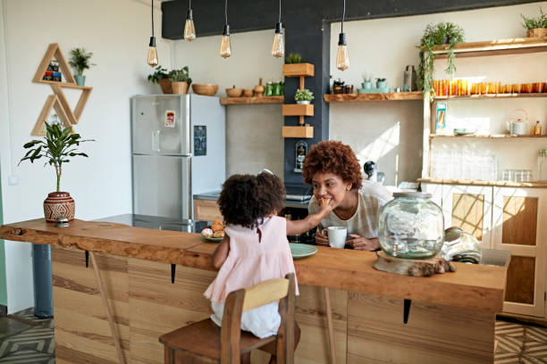 istock Afro-Caribbean Mother and Daughter Enjoying Breakfast 1257647008