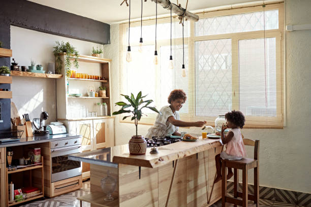 Preschool Age Daughter Enjoying Breakfast With Mother