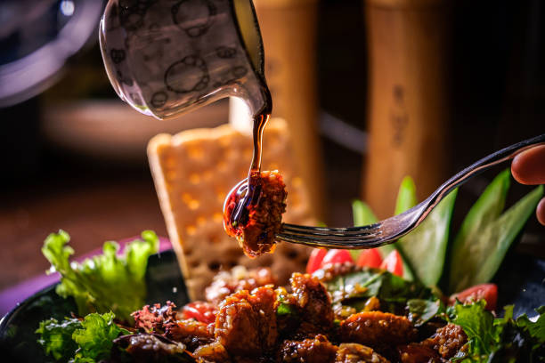 pouring dressing over a chicken salad - chicken salad grilled chicken grilled imagens e fotografias de stock