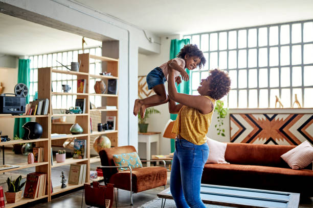 afro-caribbean mother and young daughter playing at home - retrieving imagens e fotografias de stock