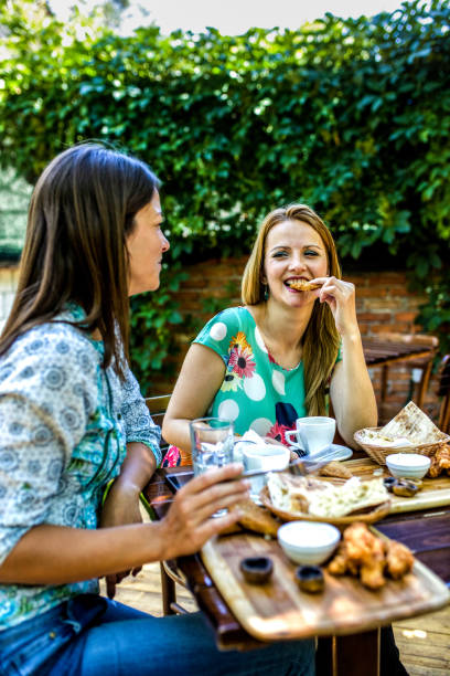 istock Two girlfriends are making fun in the cafeteria 1257650149