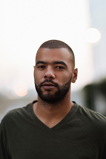 Portrait of a young bearded African American man outdoors