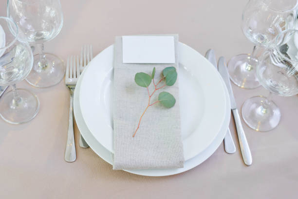 istock Wedding dinner decor, laid table with plate, Wedding calligraphy card, eucalyptus flower branch, view frome above 1257650399