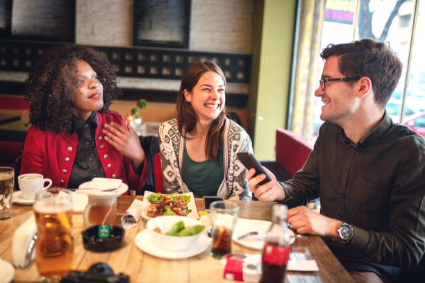 istock Diverse happy friends having fun sitting in cafe 1257651660