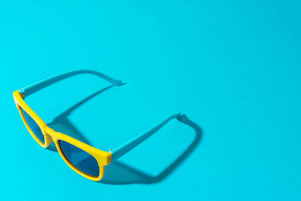 istock Plastic sunglasses on turquoise blue background in perspective with copy space 1257654553