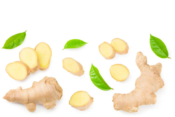 istock ginger roots with slices and green leaves isolated on white background. Top view 1257656041
