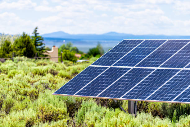 ranchos de taos valley green landscape shrubs in summer and closeup of solar panel during sunny day for off grid house in new mexico, usa - ranchos de taos imagens e fotografias de stock