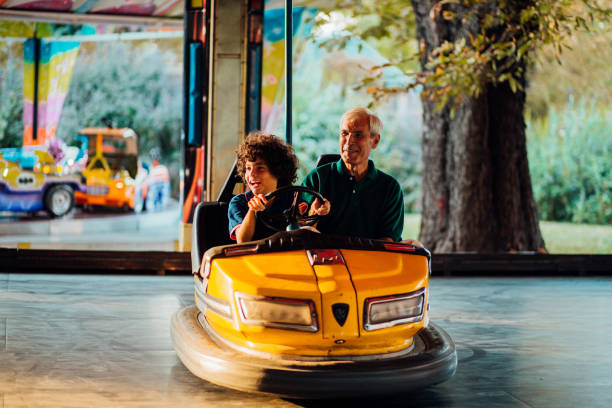 istock Boy having fun with grandpa, riding in a bumper car 1257656161