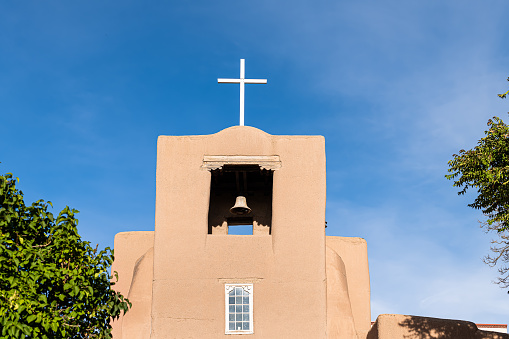 Santa Fe San Miguel Mission chapel oldest church in the United States with adobe pueblan style architecture blue cross and blue sky