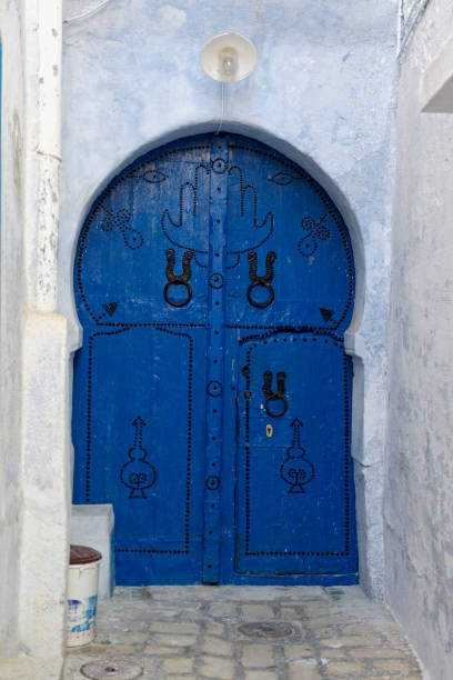 istock arabic tunisian medina blue half-round door 1257657814