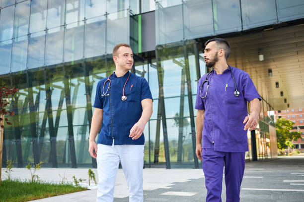 istock Medical doctors talking while leaving the hospital after work 1257659221