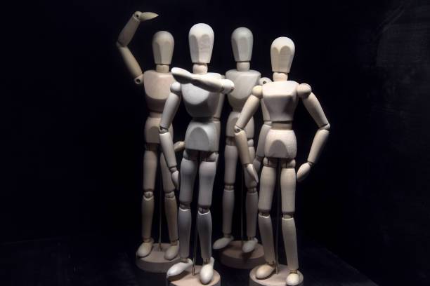 istock A drawing mannequin that points in a direction while other mannequins behind it look confused 1257660361