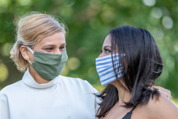 istock Mother and daughter wearing reusable protective face masks 1257661259