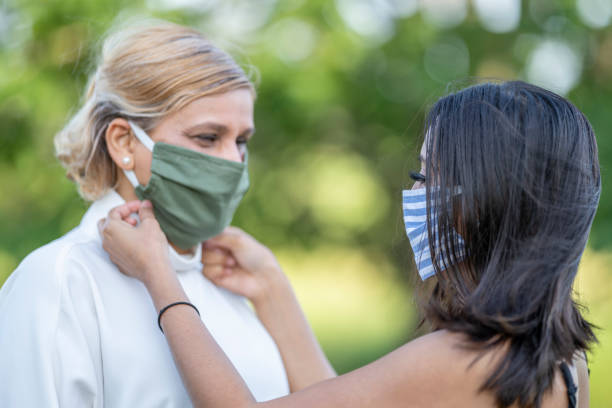 istock Mother and daughter wearing reusable protective face masks 1257661270