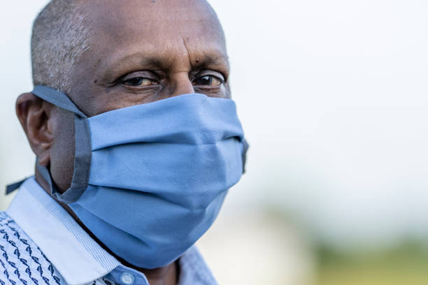 istock Mature man wearing a protective face mask outside 1257661276