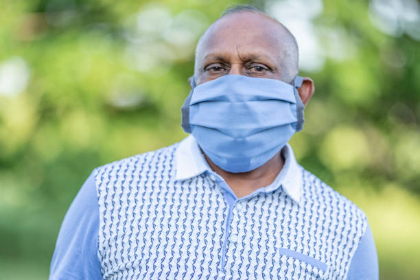 istock Mature man wearing a protective face mask outside 1257661284