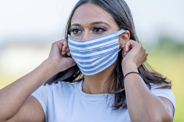 istock Beautiful West Indian female wearing a protective mask 1257661303