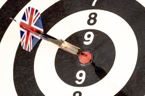 Dart with British flag board with darts in aim, with selective focus