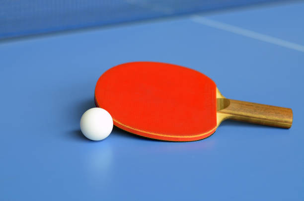istock Red Table Tennis Paddle and ball on the blue table tennis table 1257662271