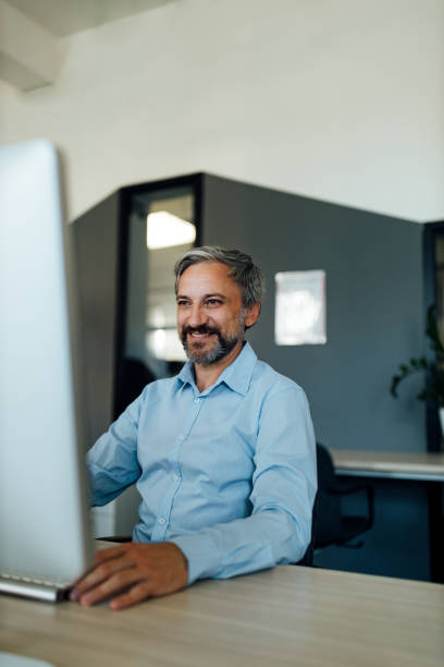 istock Portrait of a mature businessman working on computer. 1257664162
