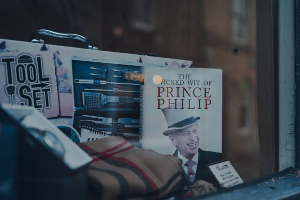 the wicked wit of prince philip book on a window display of a shop in stow-on-the-wold, cotswolds, uk, selective focus. - prince philip imagens e fotografias de stock