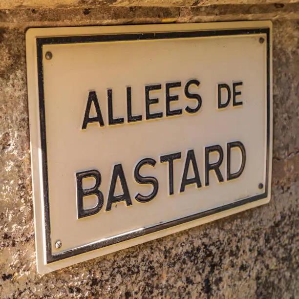 Europe, France, Dordogne, Hautefort. Street sign for the Alley of the Bastard in Hautefort.