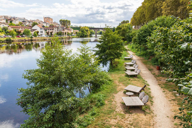 istock Chaise lounges on a pathway along the Vienne River in Limoges. 1257665515