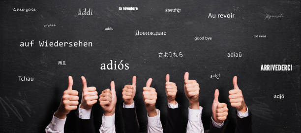 istock many thumbs up and chalkboard with message GOODBYE in different languages 1257667496