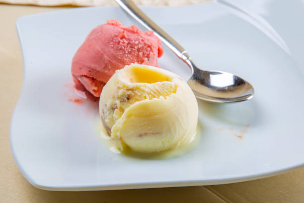istock Strawberry, lemon ice cream on white plate 1257669958