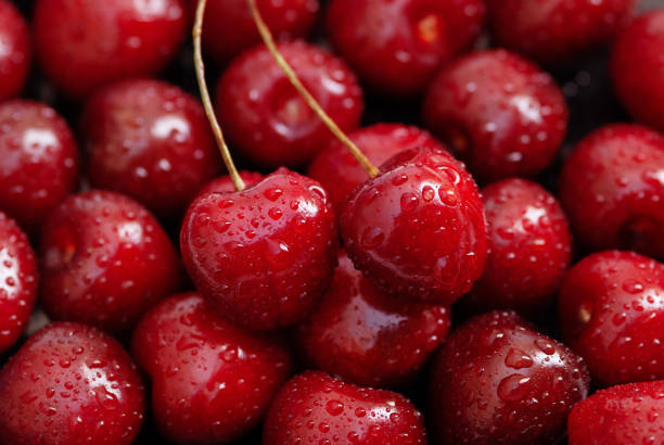 istock red ripe cherry fruit background, two cherries on top 1257672799