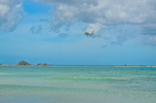 istock Jet aircraft in final approach landing at Caribbean island 1257674881