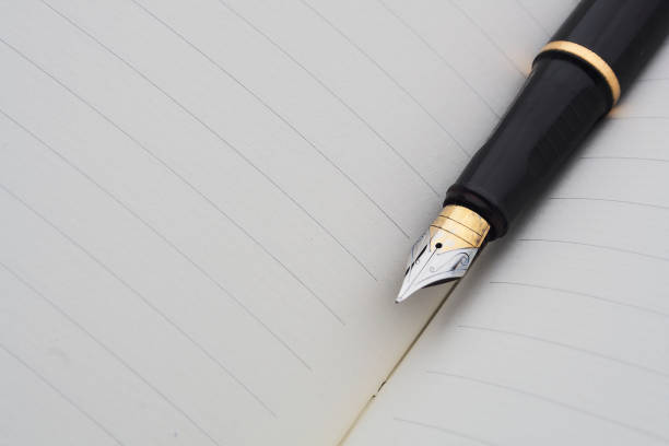 istock pen in inclined position on notebook with lines 1257676539