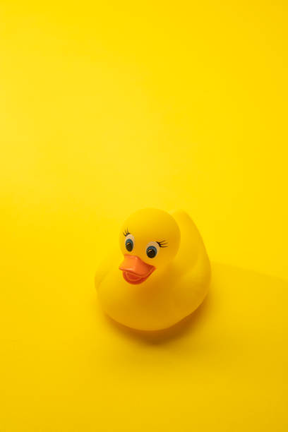 istock Bath Toy Rubber Duck on Yellow Background 1257677496