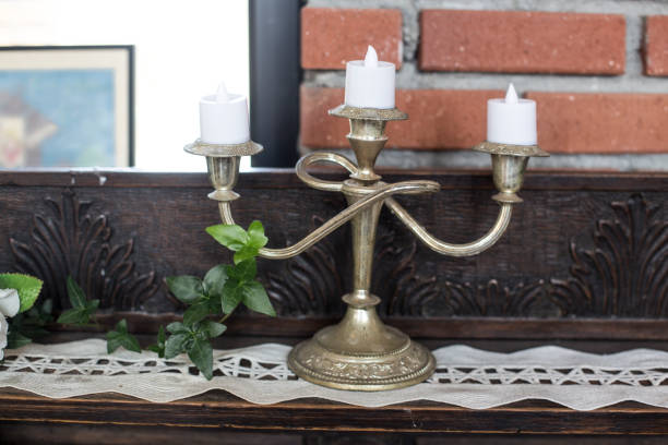 istock Vintage candlestick with candles in front wall. 1257685373