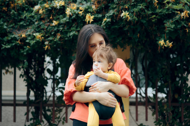 istock Mother Walking Baby Outdoors in Baby Wearing System 1257689934