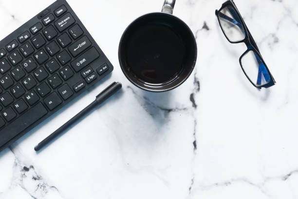 istock high angle view of modern workplace with coffee cup and keyboard 1257691038
