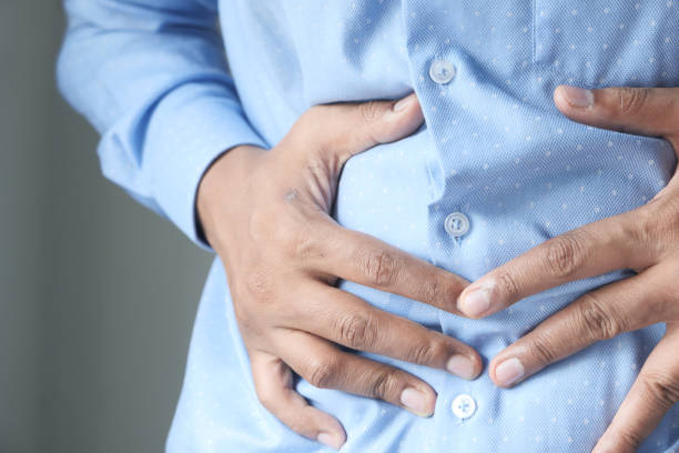 istock man touching stomach suffering pain close up. 1257691807