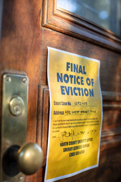 Eviction notice on door of house Eviction notice on door of house with brass door knob. Fictitious address, ID, signature and 555 phone number for fictional usage. real estate outdoors vertical usa stock pictures, royalty-free photos & images