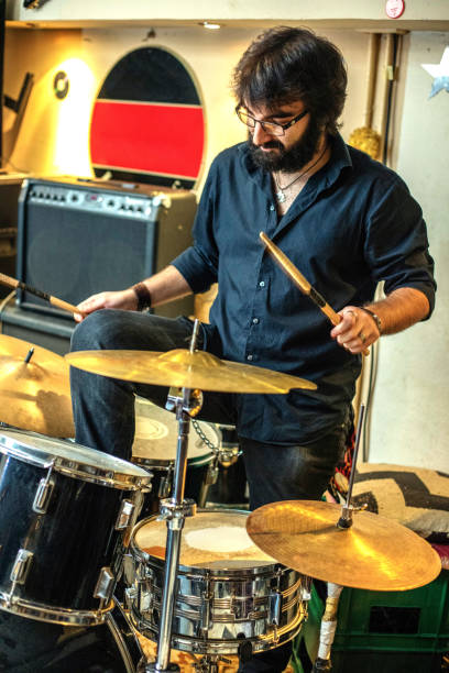 istock Modern caucasian man play on drums 1257696010