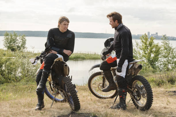 istock Motorcyclists chatting near lake 1257697166